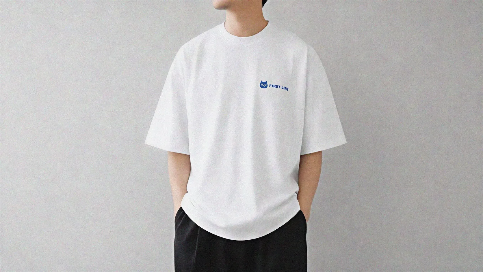 模特兒穿著繡有客服貓與 FIRST LINE 字樣的寬版白色上衣